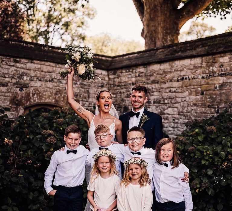 Bride and groom pose with their son, daughter, niece and nephews 