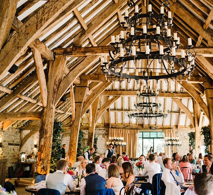 Tithe Barn wedding venue complete with rustic wooden beams and exposed brick walls 