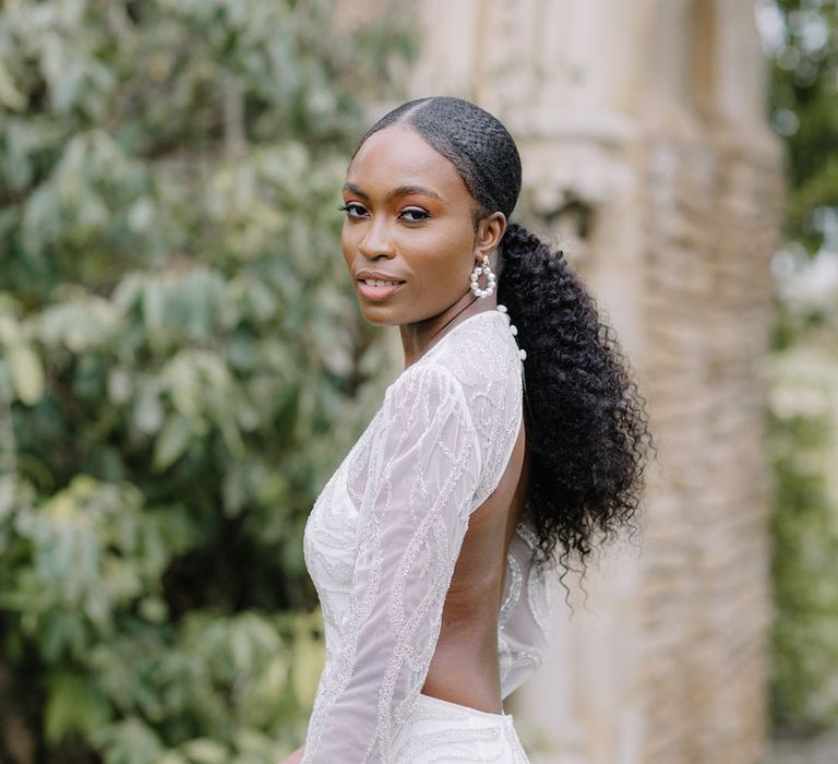 Black bride in a glitzy open back wedding gown