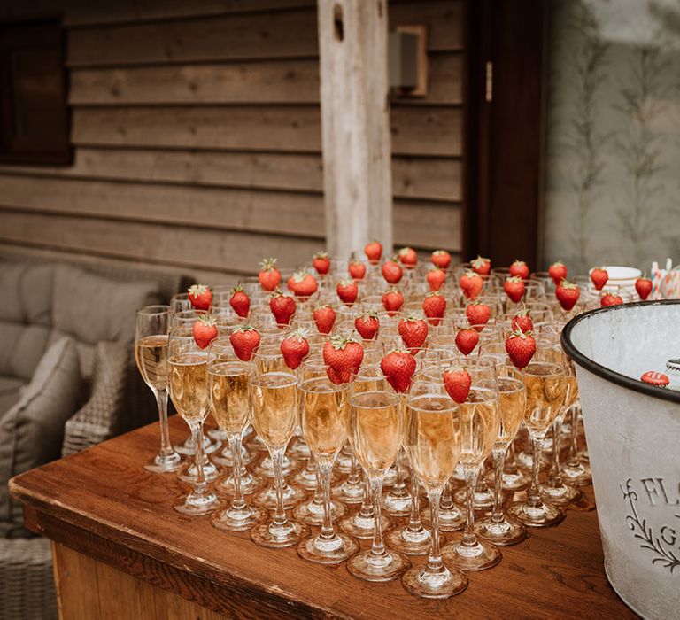 Outdoor bar area with glasses of champagne and strawberries for drinks 