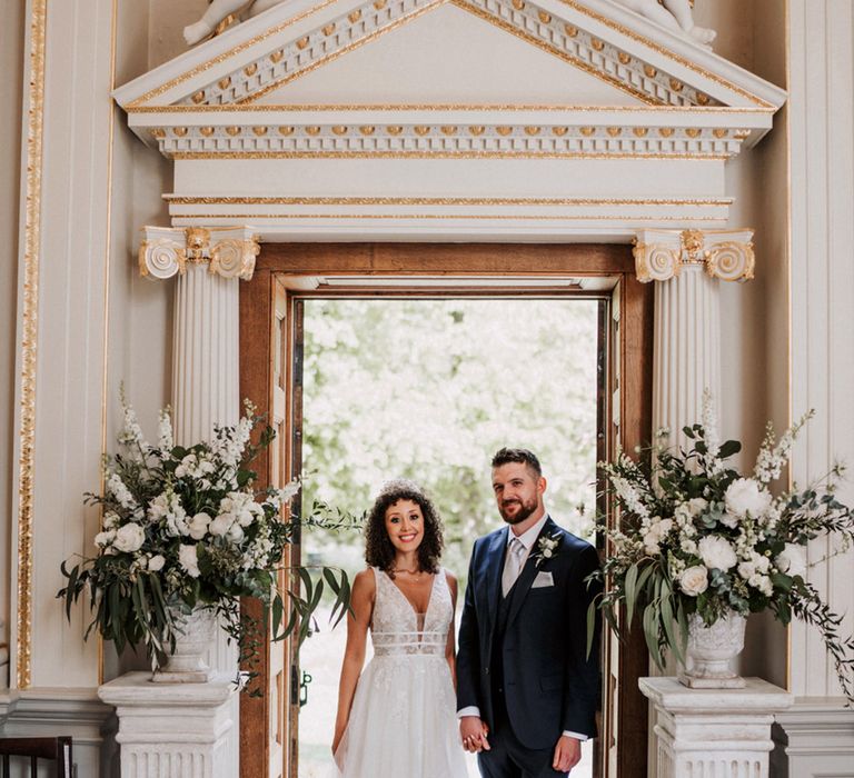 Bride in boho styled wedding dress stands beside her groom at the Orleans House Gallery