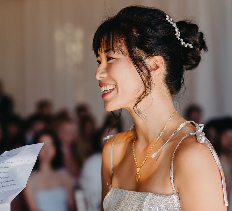 East Asian bride wears pearl hair accessory within her dark hair 