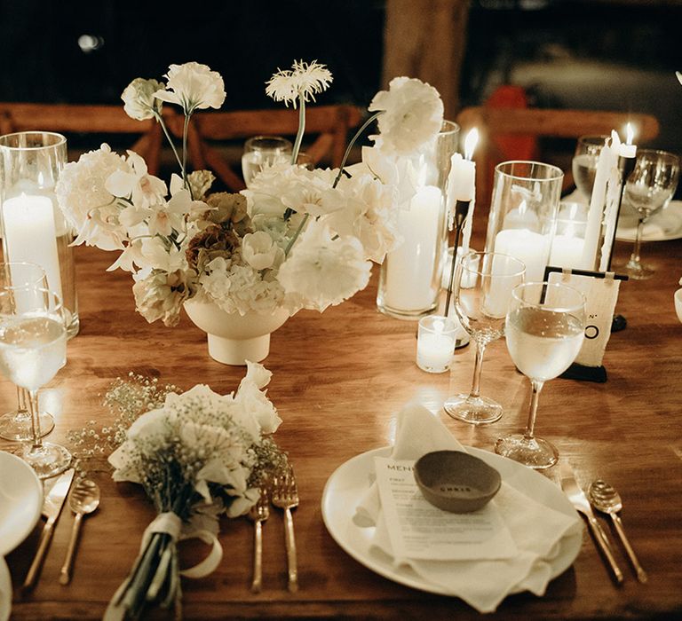 white pillar candles and taper candles in black candle holders as wedding table decorations at destination wedding 