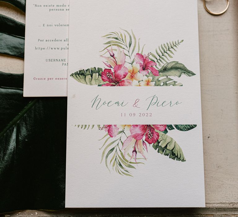 white pink and green wedding invitation with tropical flower design