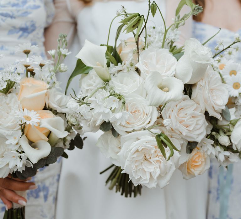 White flower wedding bouquet with roses and lilies 