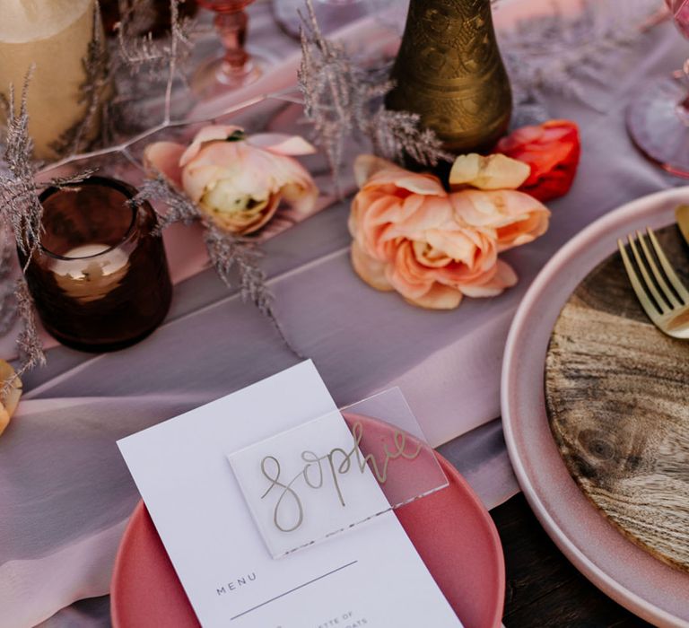 Clear acrylic wedding place name with wedding menu card on pink mini plate