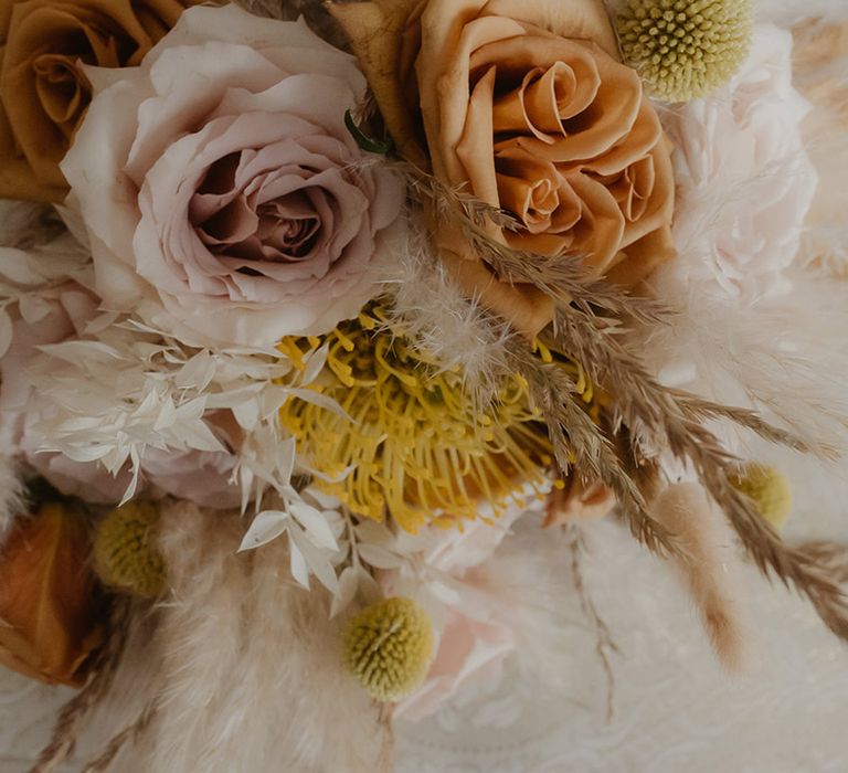 dried and fresh neutral wedding flowers with pampas grass and roses 