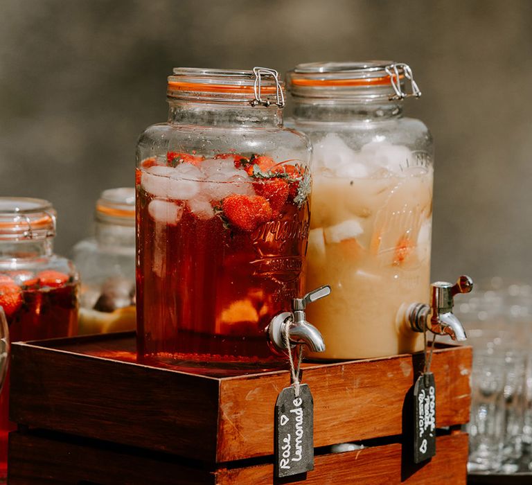 Wedding drinks hydration station with glass dispensers filled with juices 