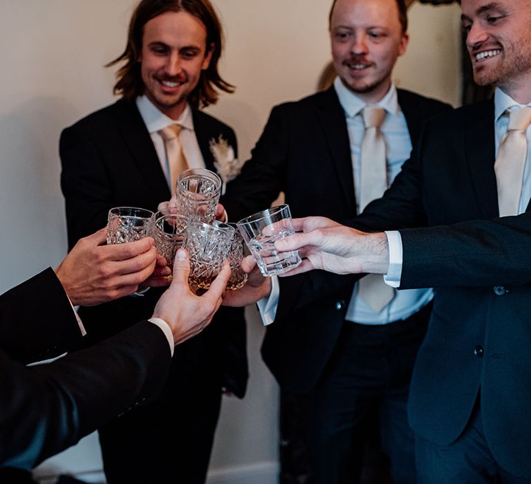 The groomsmen cheers together as they prepare for the wedding 