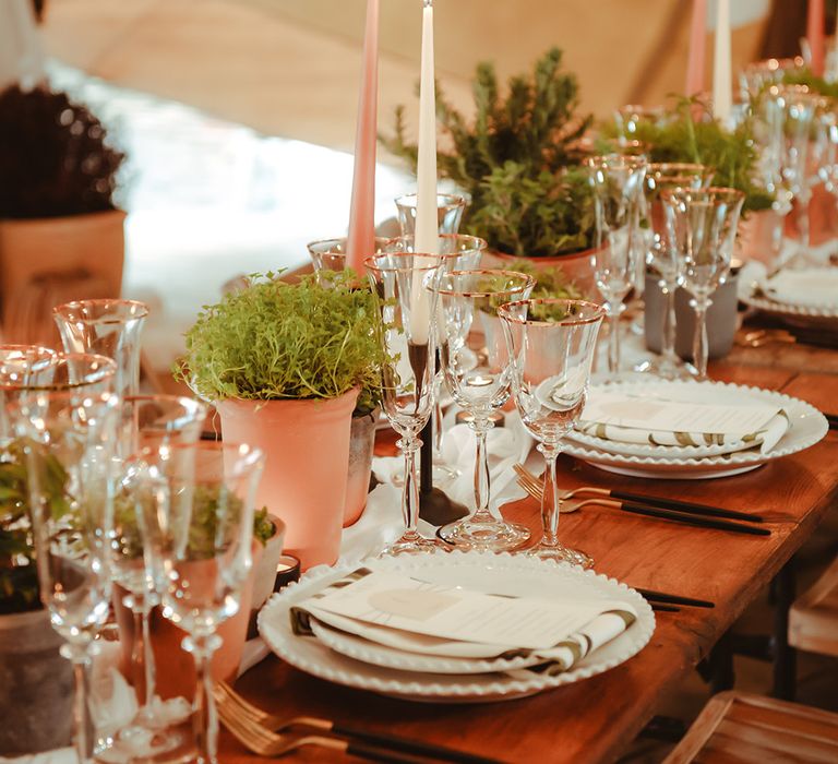 Simple minimalist wedding tablescape with grey and peach wedding taper candles and foliage decorations 