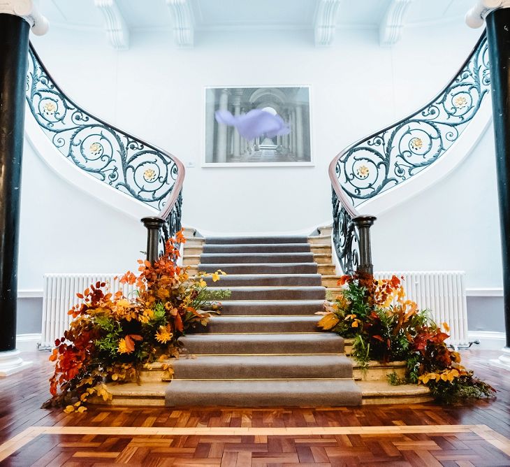 Staircase floral arrangements at Carlton House Terrace wedding