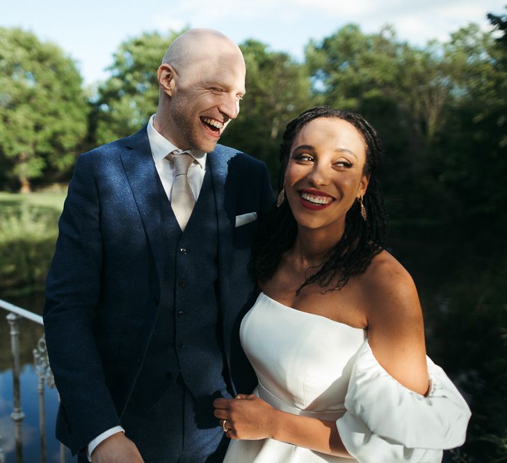 Bride and groom smiling at Morden Hall wedding 