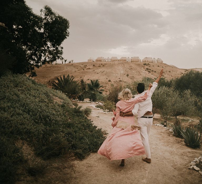 Bride and groom at Marrakech wedding with bride in pink dress 