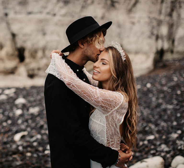 Bride and groom embracing at beach elopement 