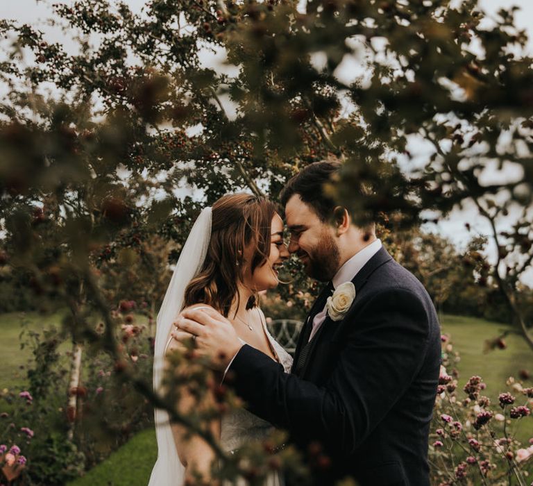 Laughing bride and groom in a garden