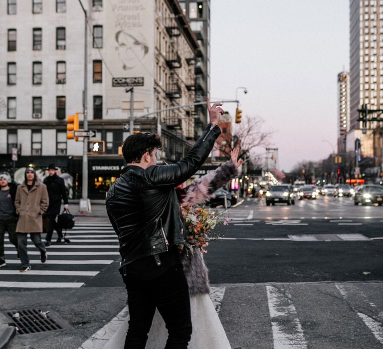 Bride & groom hail taxi in New York 