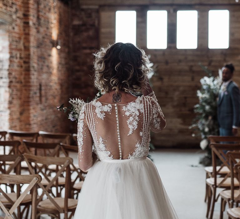 The bride wore a short curly wedding hairstyle