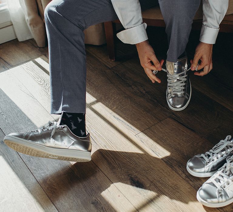 Bride and groom in matching silver shoes 