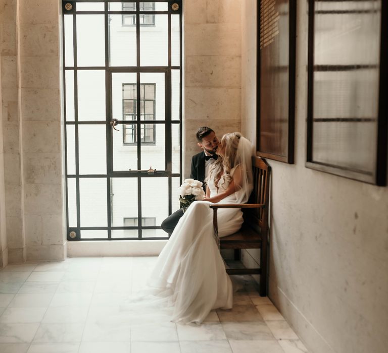 Bride & groom sit together on wedding day