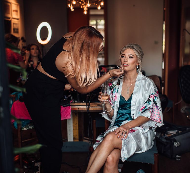 Bride has her makeup done on the morning of her wedding