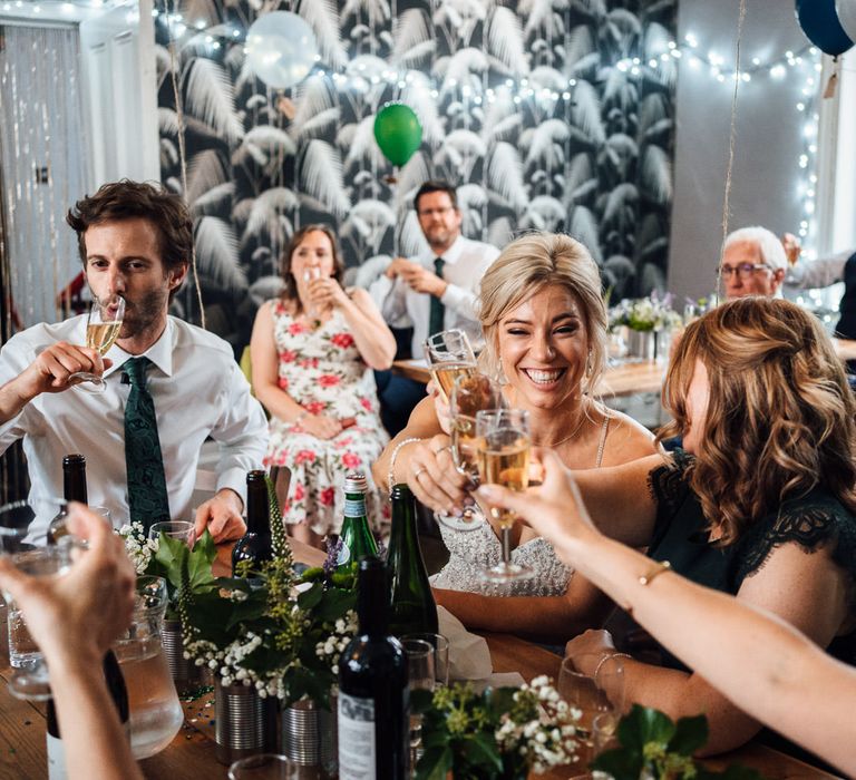 Bride laughs during wedding reception with friends