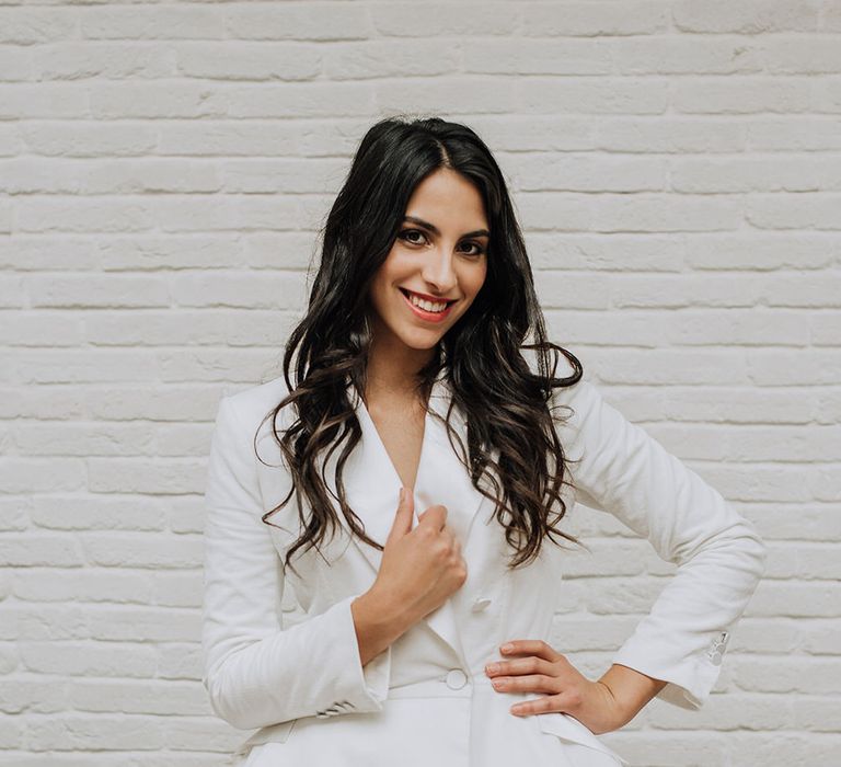 Bride wearing a short wedding dress in a unique tutu skirt and blazer style