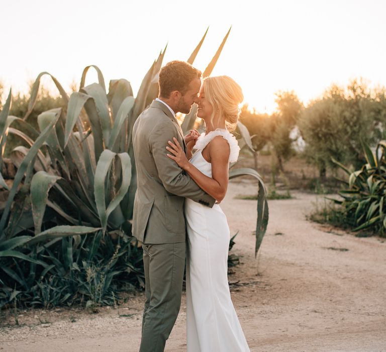 The bride and groom together surrounded by huge succulent plants