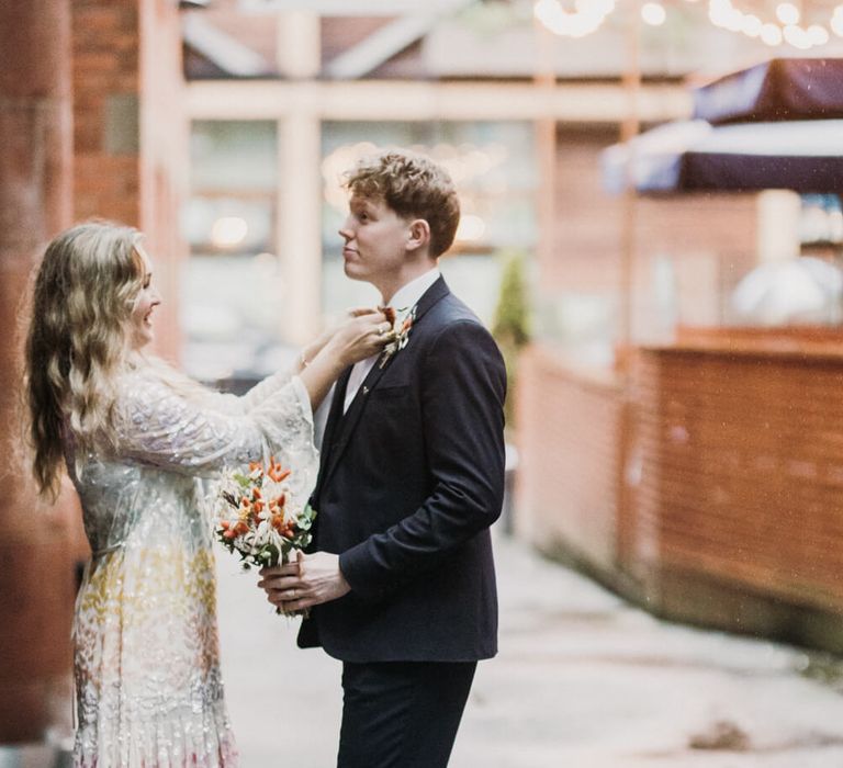 Bride fixing grooms bow tie | Manchester micro wedding