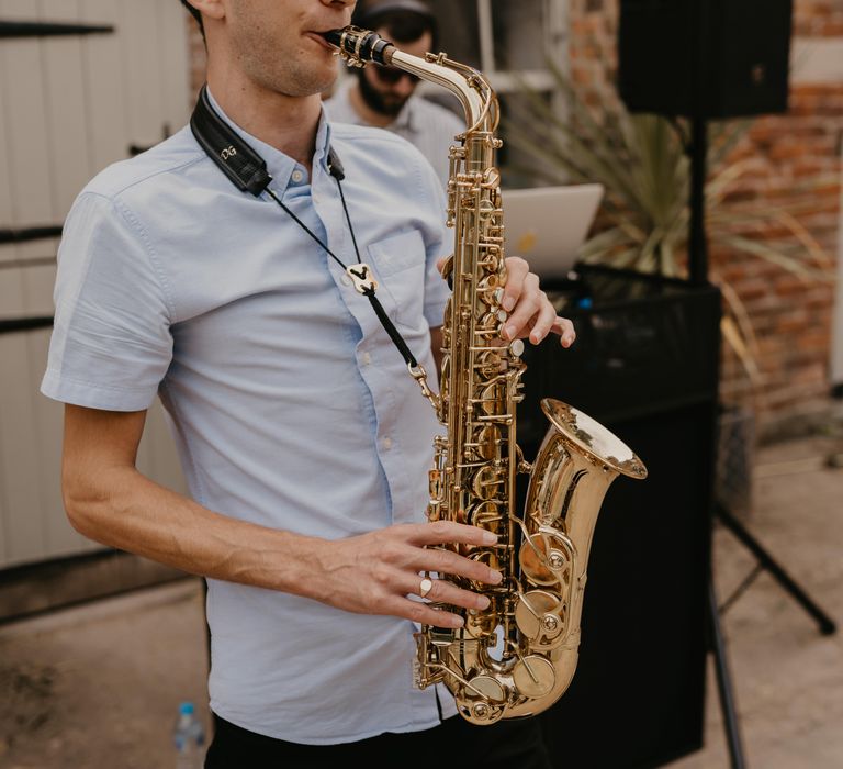 Saxophone player during beginning of wedding reception | Mark Bamforth Photography