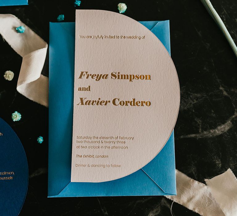 Stylish wedding invitation with gold foil font and teal envelope 