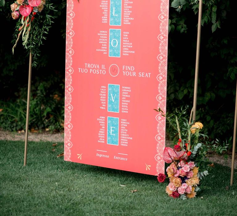 Wedding table plan complete with orange background and pale blue lettering spelling LOVE 