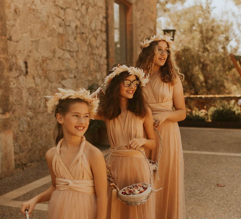 Flower girls wear neutral gowns and flower crowns