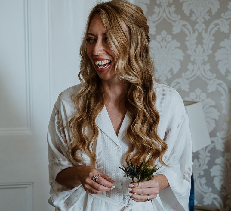 Bride wears her blonde hair in loose waves for wedding day look