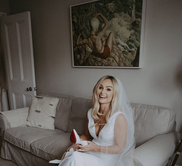 Bride smiles as she gets ready for wedding