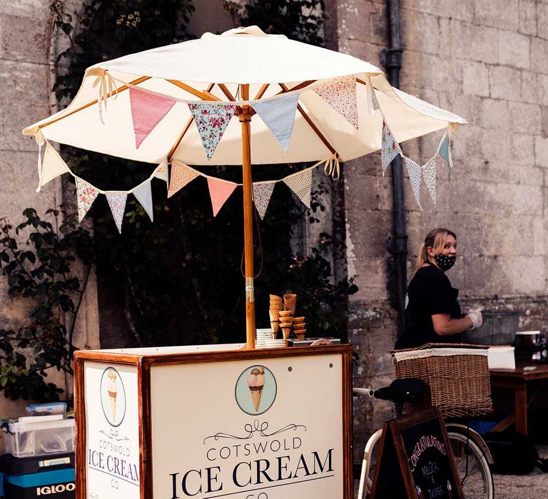 Cotswold Ice Cream Co. cart with umbrella and bunting for Elmore Court wedding 