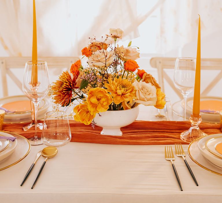 orange and yellow golden wedding flower arrangement and taper candles wedding table decor 