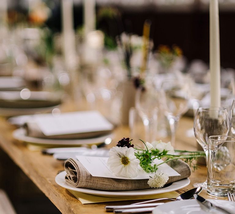 Table setting with fabric napkins and dainty flowers for country house wedding