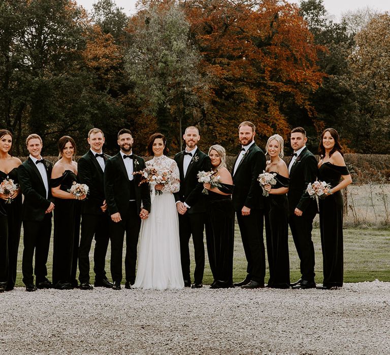 Wedding party in black tie and green velvet bridesmaid jumpsuits and bride in sweetheart illusion lace long sleeve dress 