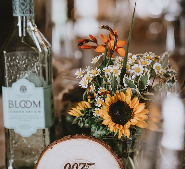 Sunflower flower arrangement with wood slice table centrepiece decor to show off their favourite fandoms that mean a lot to the couple 