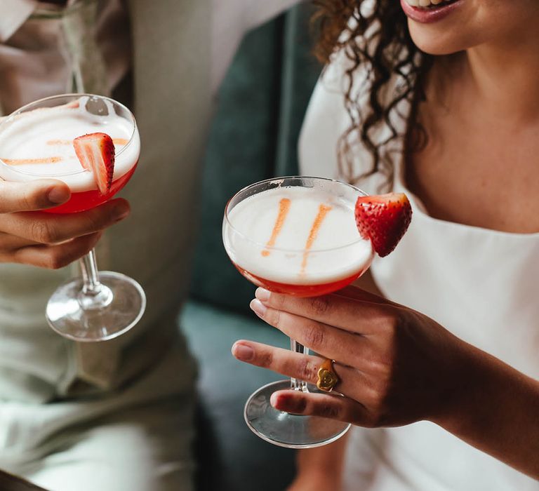 Bride and groom drinking strawberry daiquiri's at pub wedding 