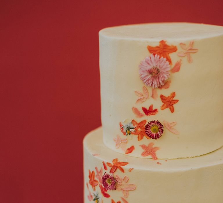 Three tier frosted wedding cake with pink minimal flower wedding cake 