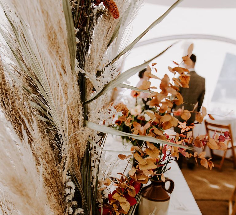 Dried pampas grass and Autumnal coloured florals for boho styled wedding day