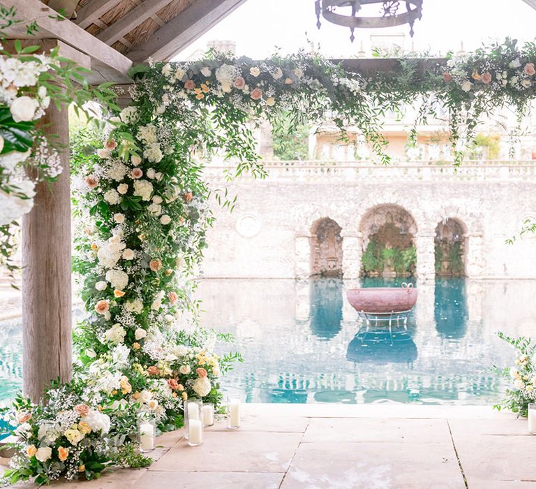 Epic and large yellow wedding flowers and pillar candles in vases 