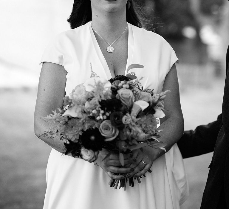 Bride smiles as she catches a glimpse of the bride for their outdoor wedding ceremony at John Muir Alpacas