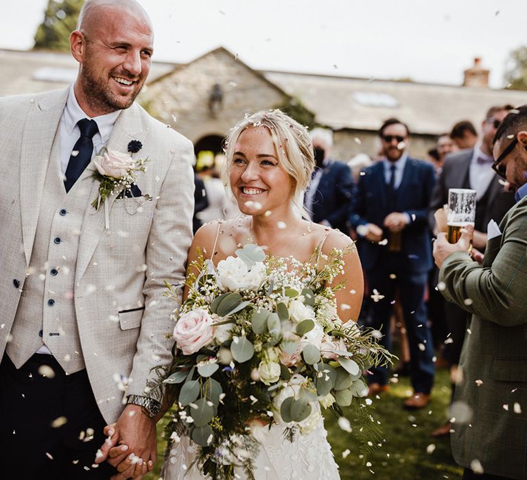 Fun confetti moment for the bride and groom after their ceremony