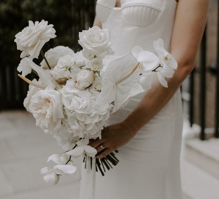 The bride's white wedding bouquet with orchids, roses, anthuriums and more 