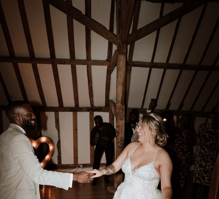 The bride and groom share their first dance together 