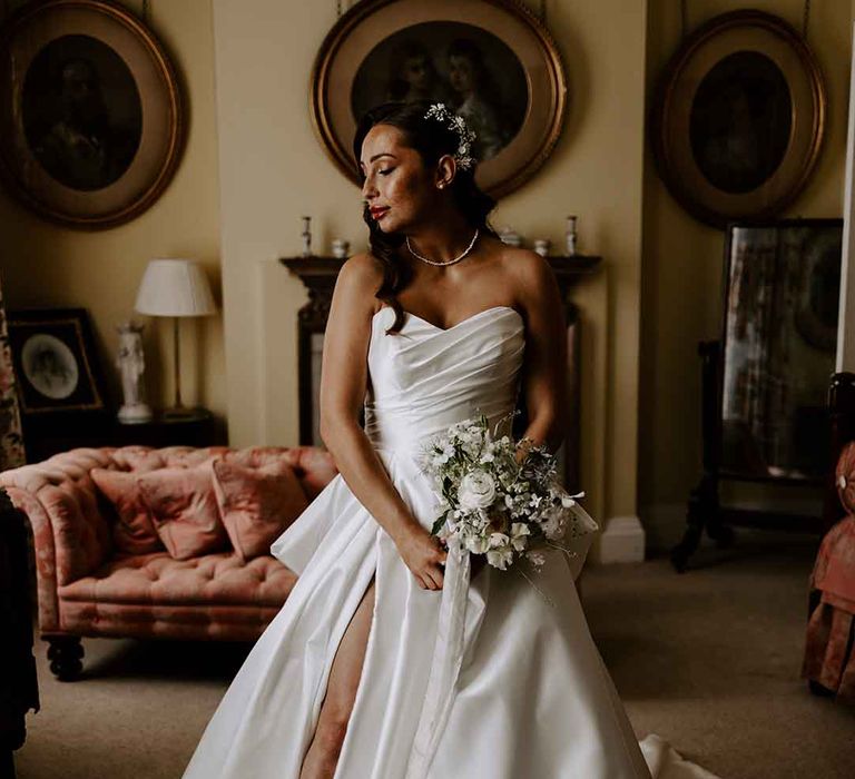 Bride in a strapless wedding dress with front slit 