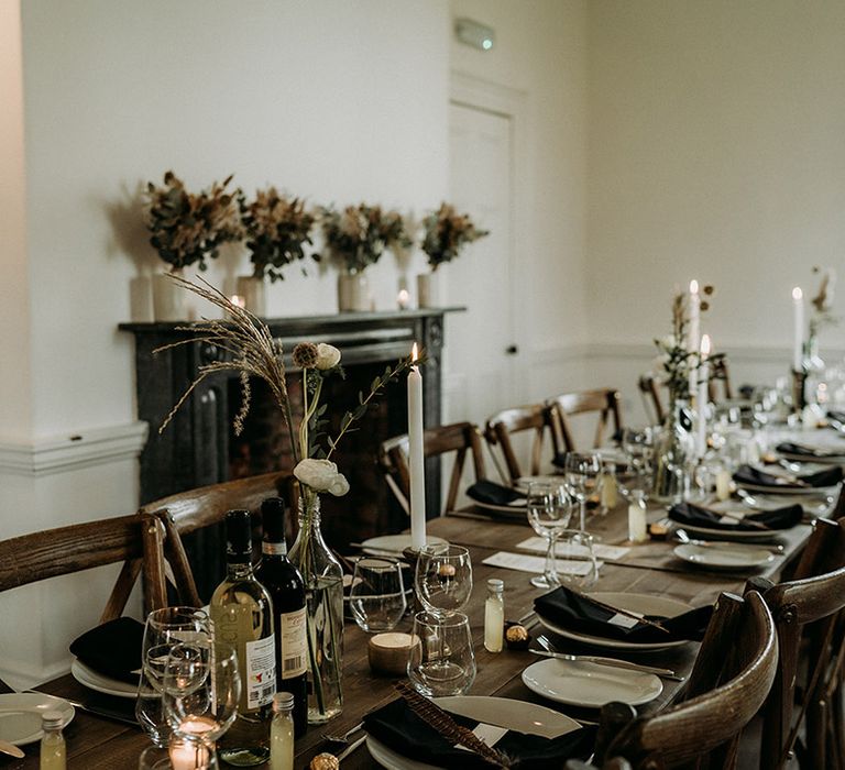 Simple, neutral and minimal wedding tablescape with white flowers and candles 