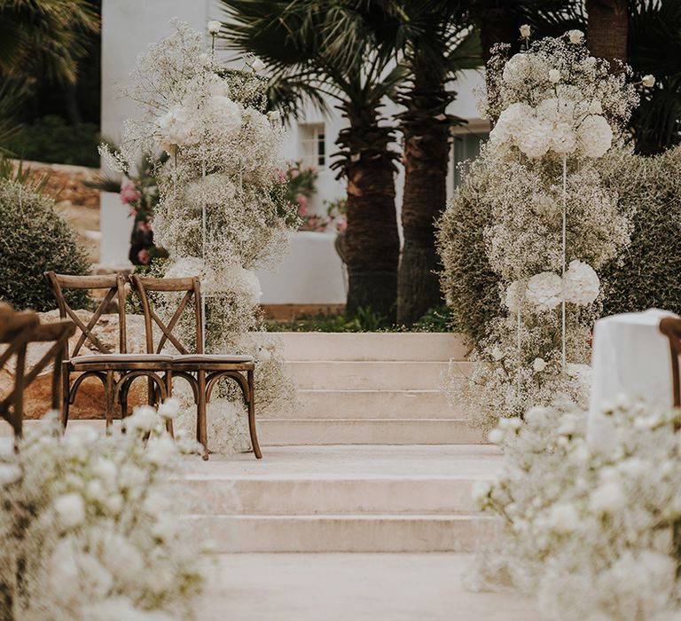 white gypsophila clouds and hydrangea column wedding ceremony flowers